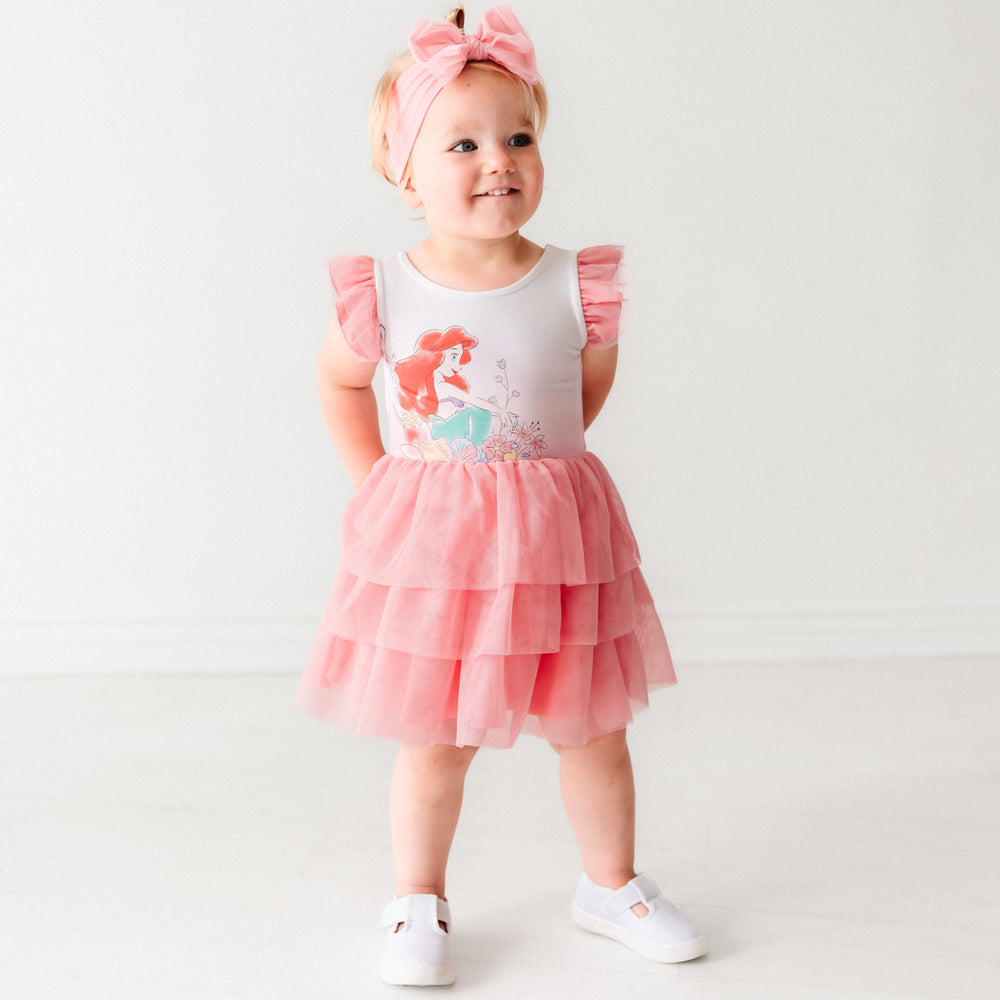 Child wearing an Ariel flutter tiered tutu dress with bloomer and matching tulle luxe bow headband