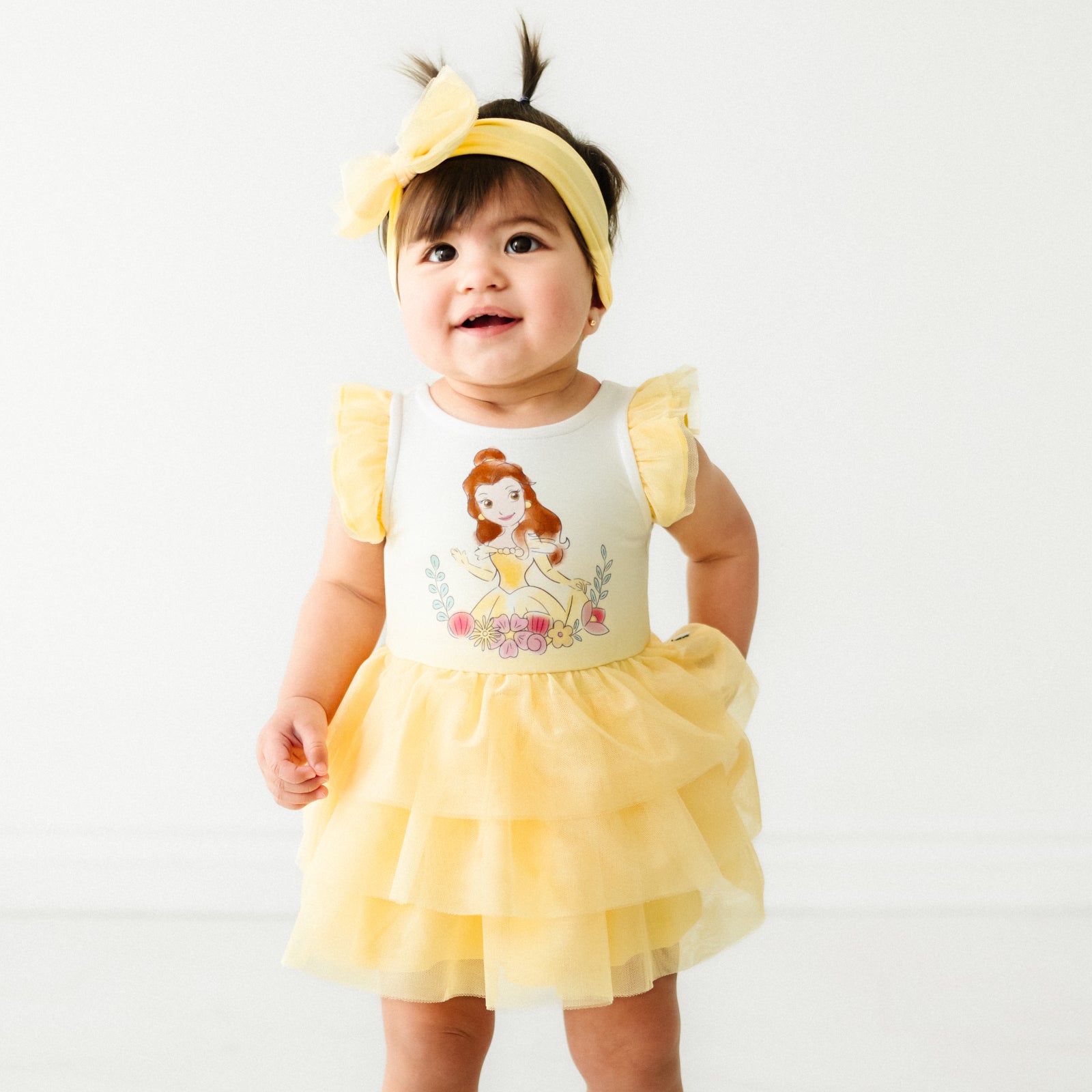 Child wearing a Yellow tulle luxe bow headband and matching dress