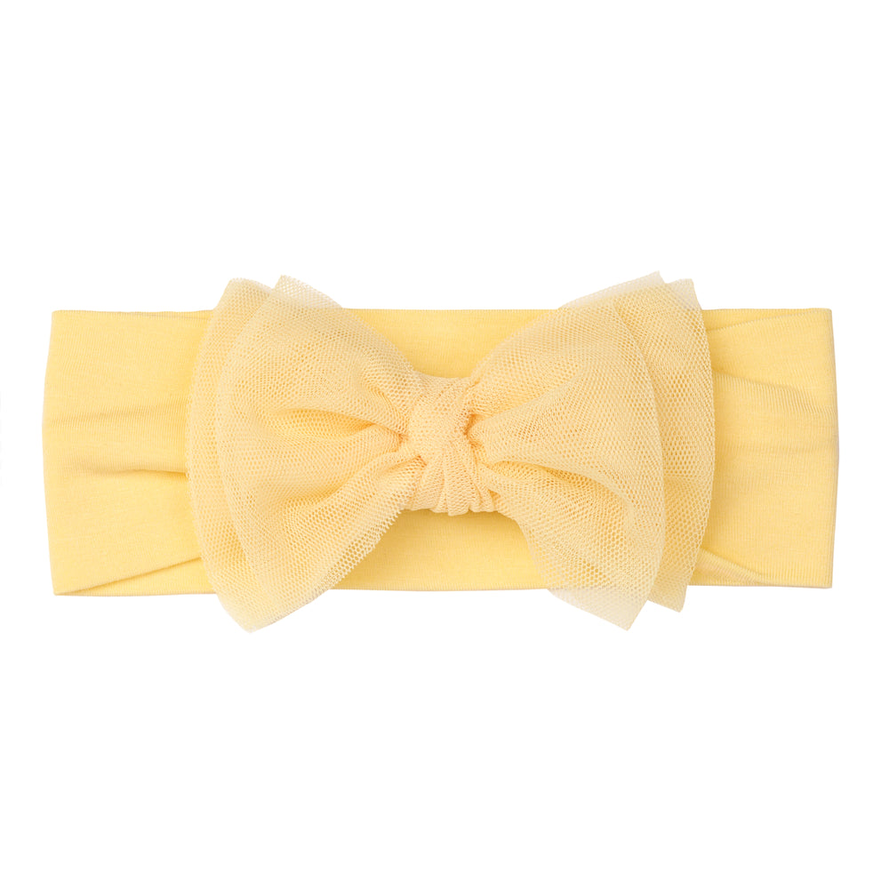 Flat lay image of a Yellow tulle luxe bow headband