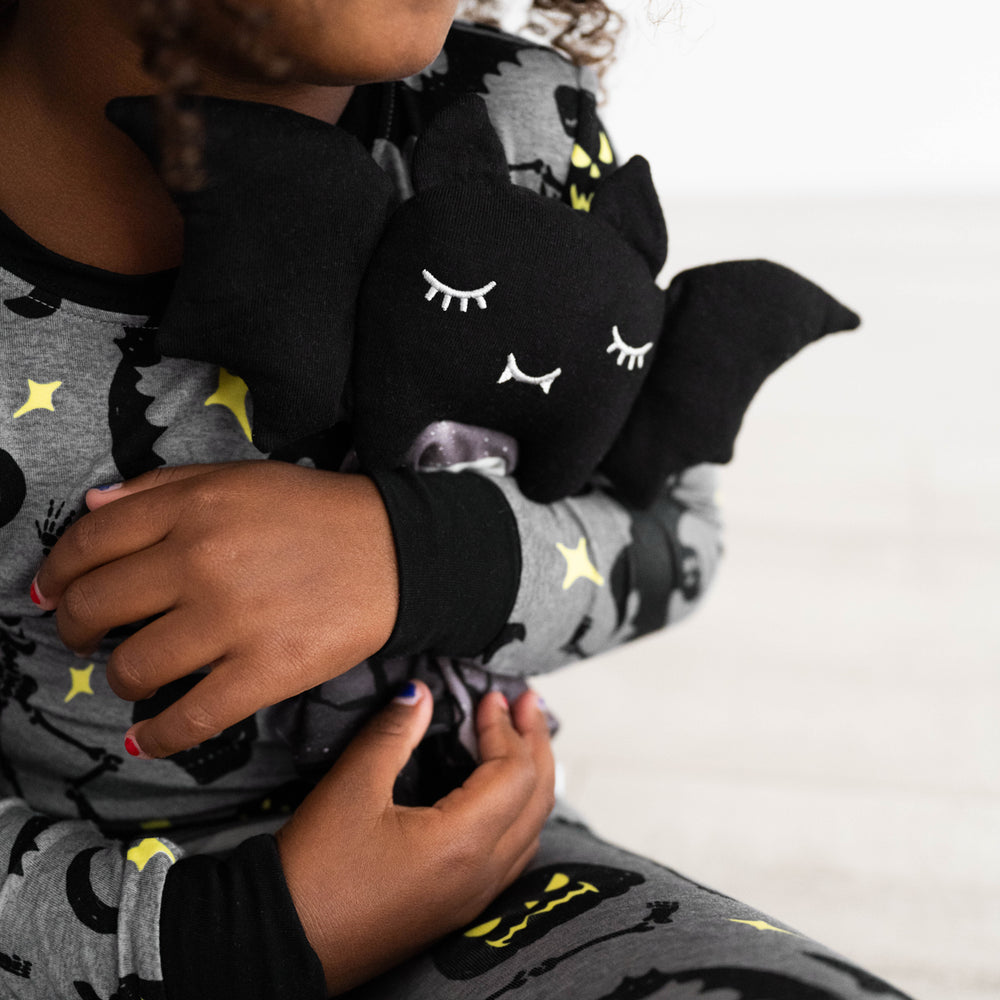 Alternative close up image of child holding Benny the Bat Sleepyhead Lovey