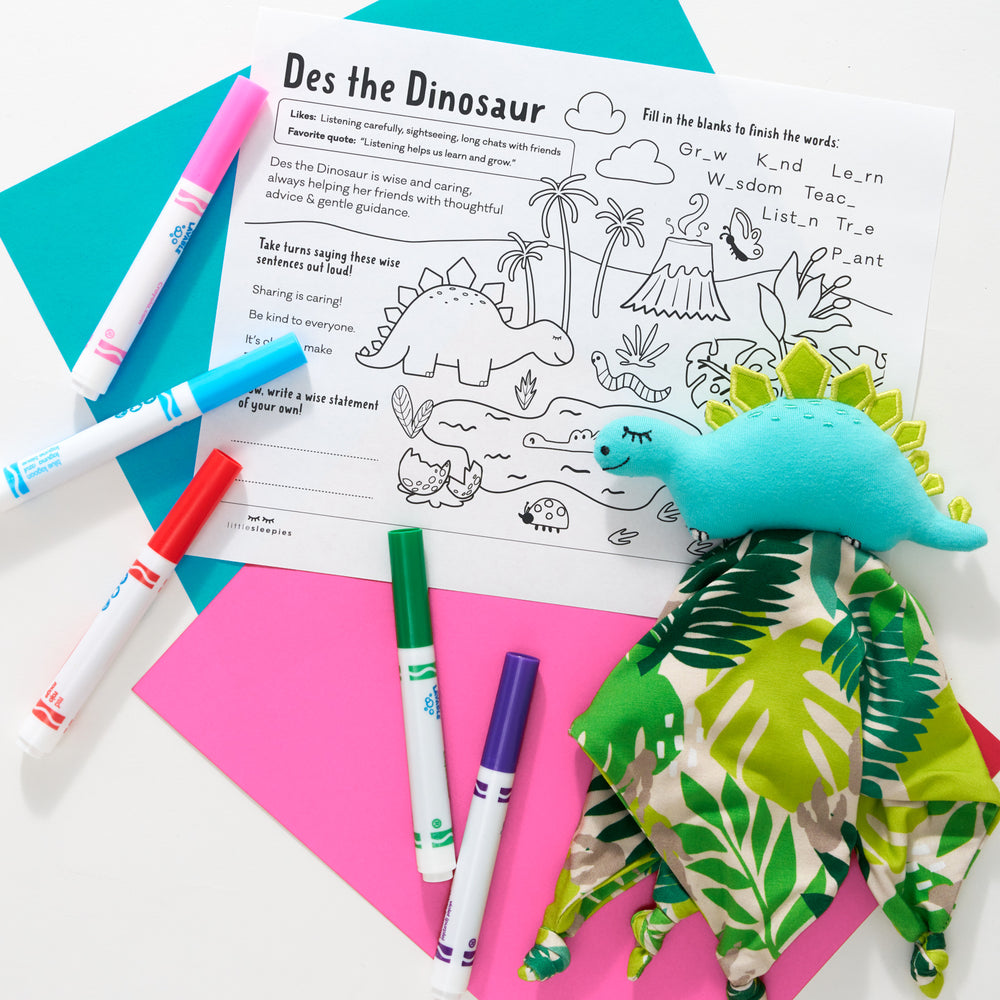 Flat lay image of Des the Dinosaur with her accompanying coloring pages