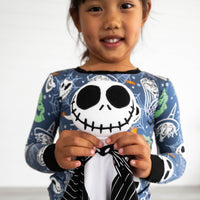 Close up image of girl holding the Disney Jack Skellington Lovey