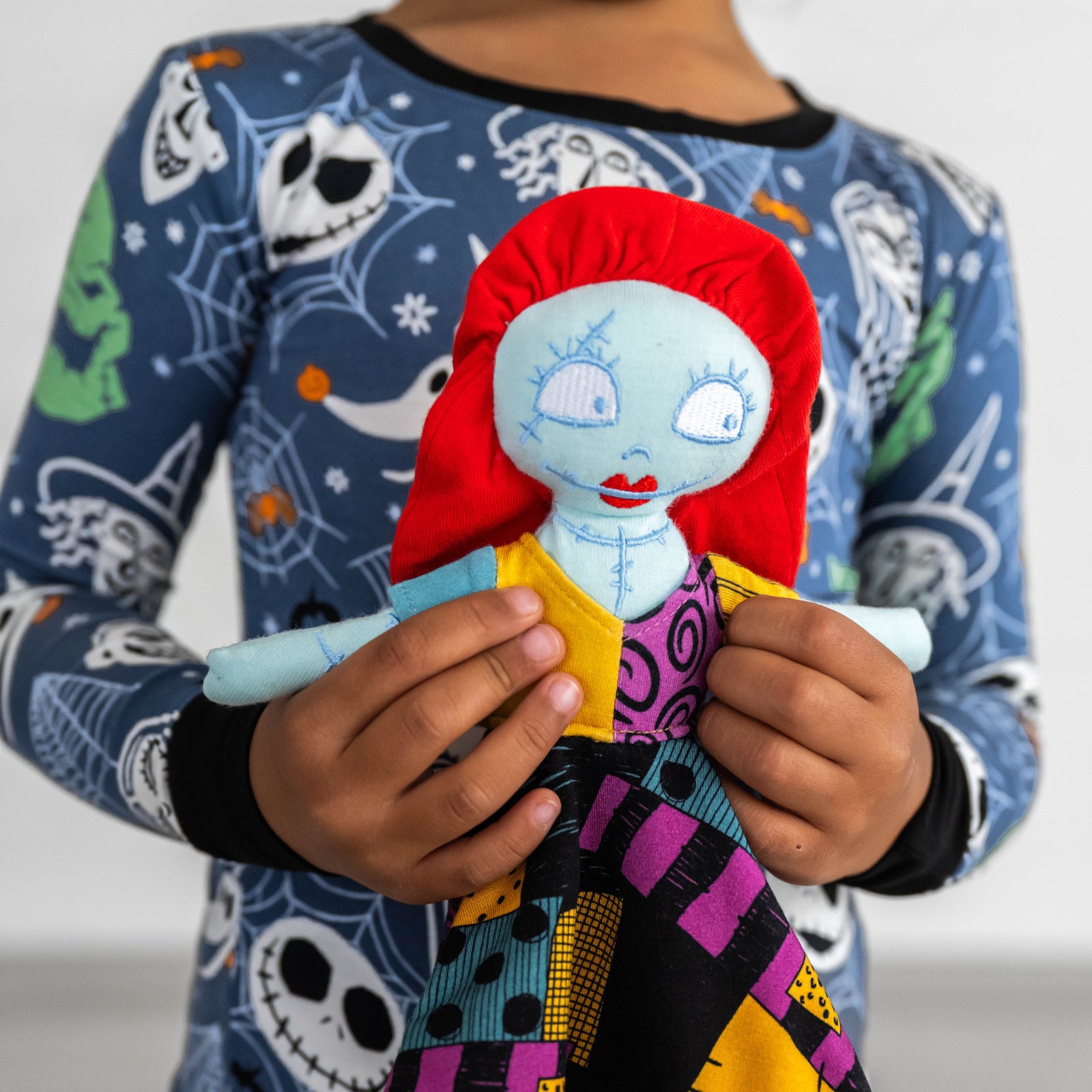 Close up image of child holding the Disney Sally Lovey