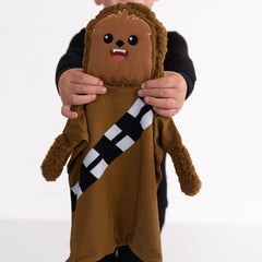 image of a child holding up a Chewbacca Lovey