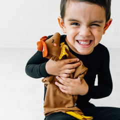 Child hugging his Harley the Horse lovey