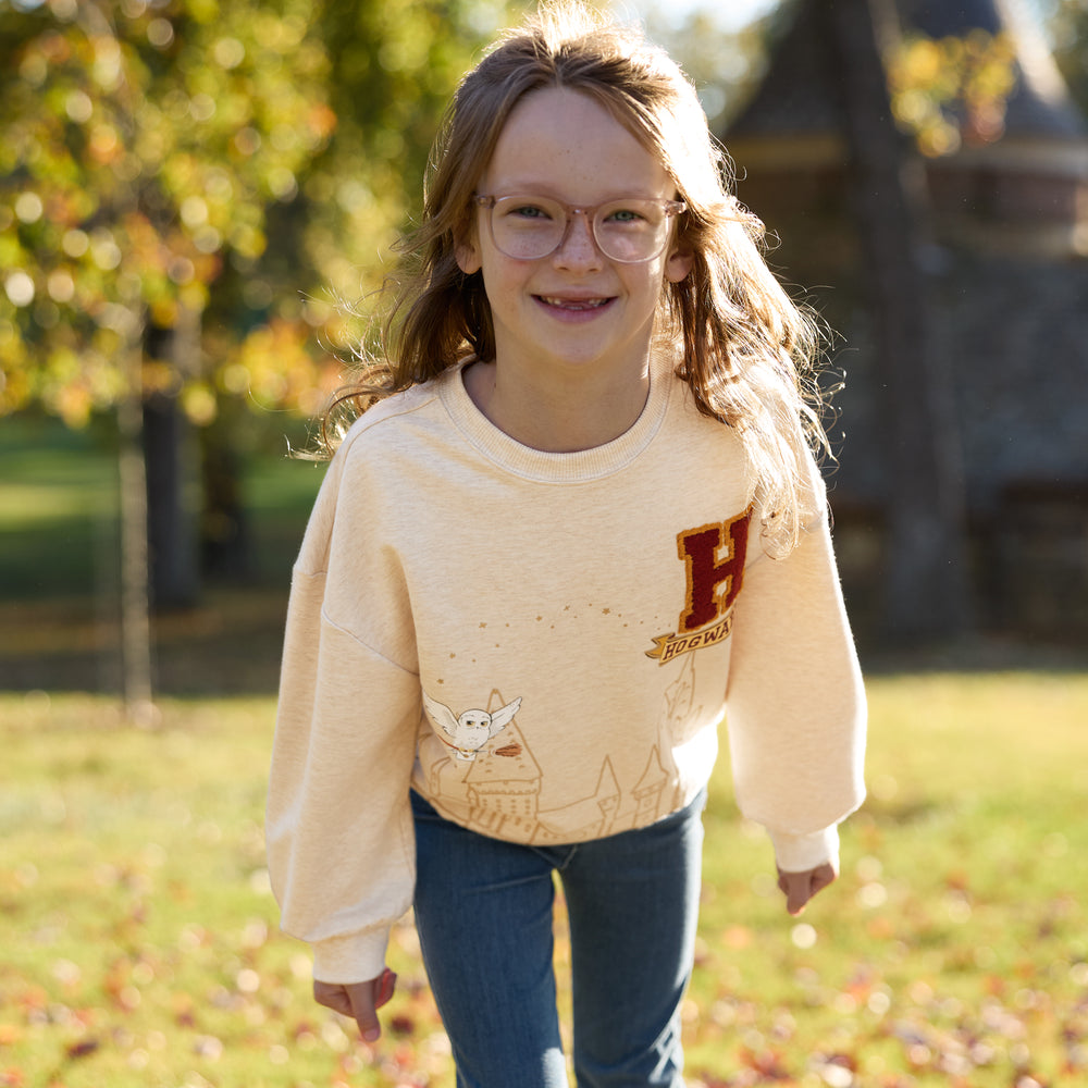 Image of a child outdoors wearing a Harry Potter Drop Shoulder Crewneck and coordinating jeggings