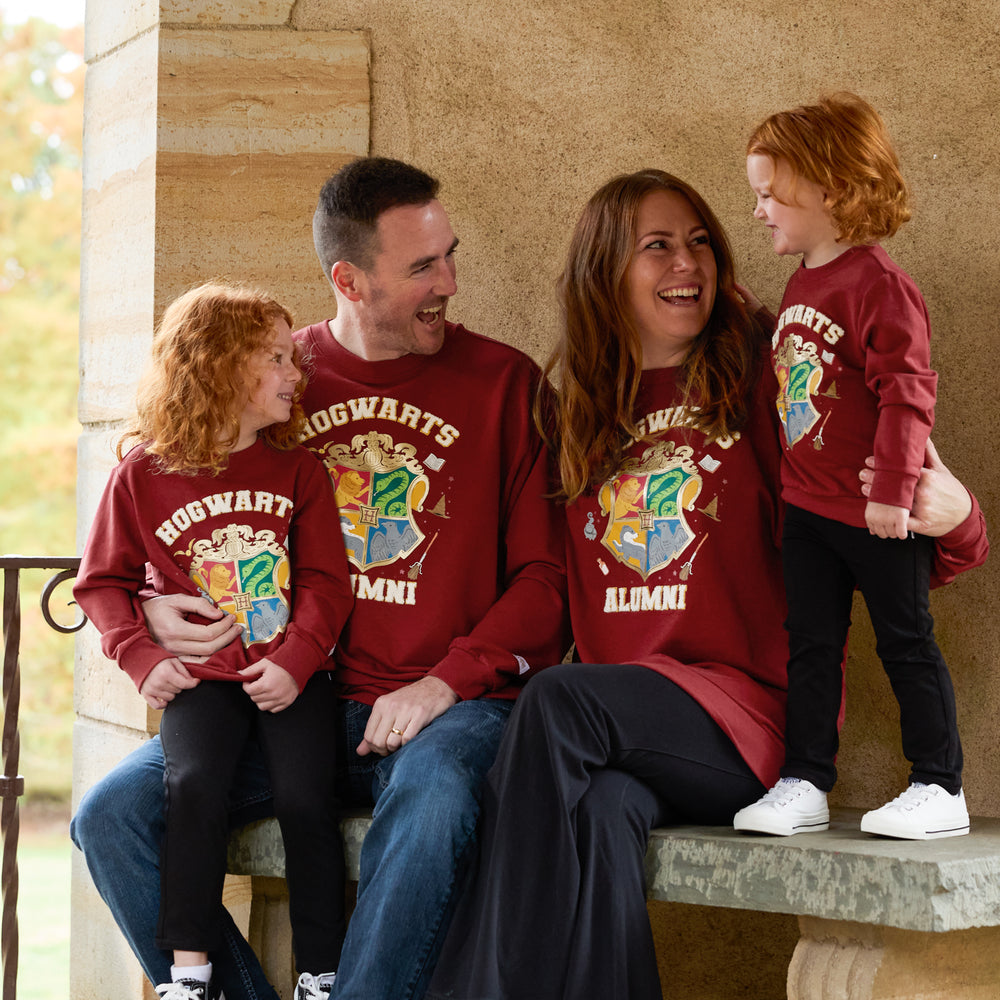 Family of four wearing matching Hogwarts Crewneck Sweatshirts