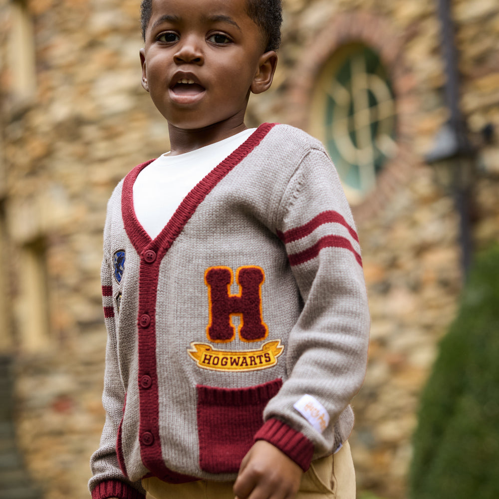 Image of a child outdoors wearing a Harry Potter Varsity Cardigan