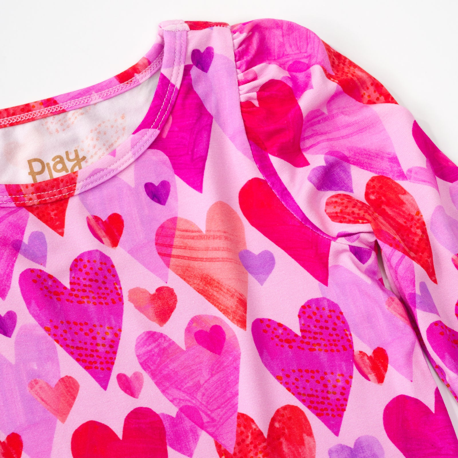 close up flat lay of a pink hearts & crafts puff sleeve tee