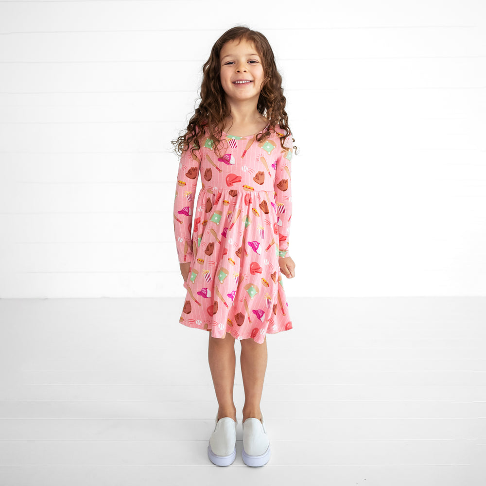 Image of a child wearing a Pink All Stars Twirl Dress