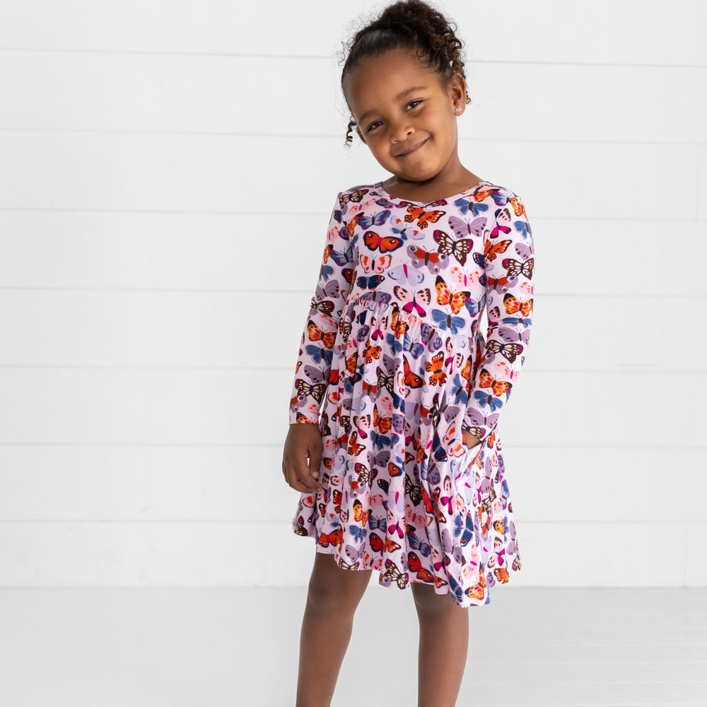 Additional image of girl posing while wearing the Butterfly Kisses Twirl Dress