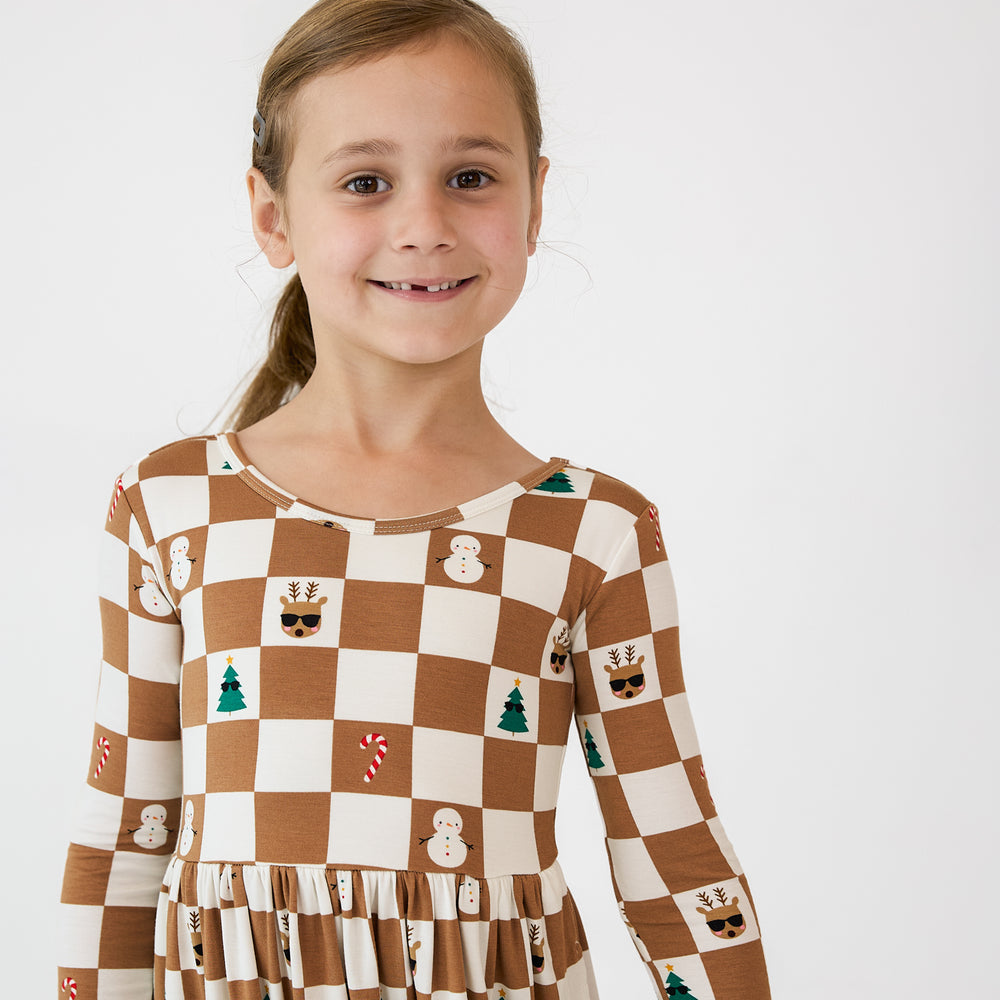 Close up image of a child wearing a Holiday Checks Skater Dress