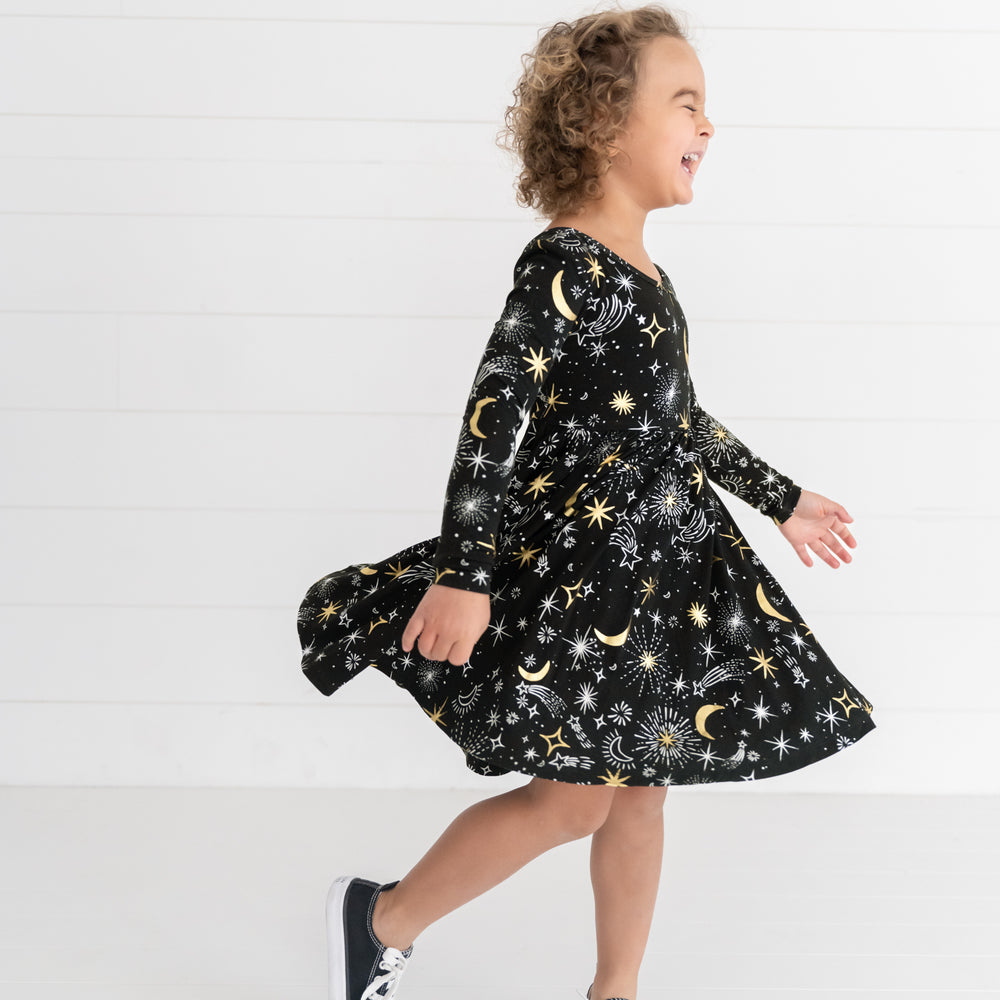 Image of a girl spinning around wearing a Celebration Stars Twirl Dress