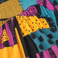 Close up image of the pink, yellow, black and teal pattern on the 