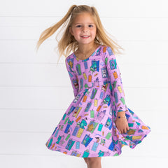 Smiling girl spinning and posing while wearing the Disney Monsters, Inc. Scream Team Twirl Dress