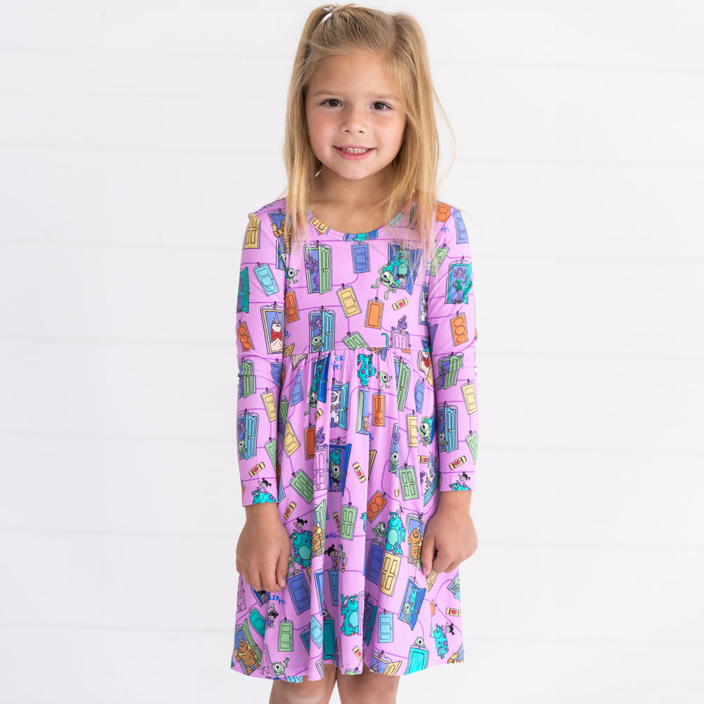 Smiling girl wearing the Disney Monsters, Inc. Scream Team Twirl Dress