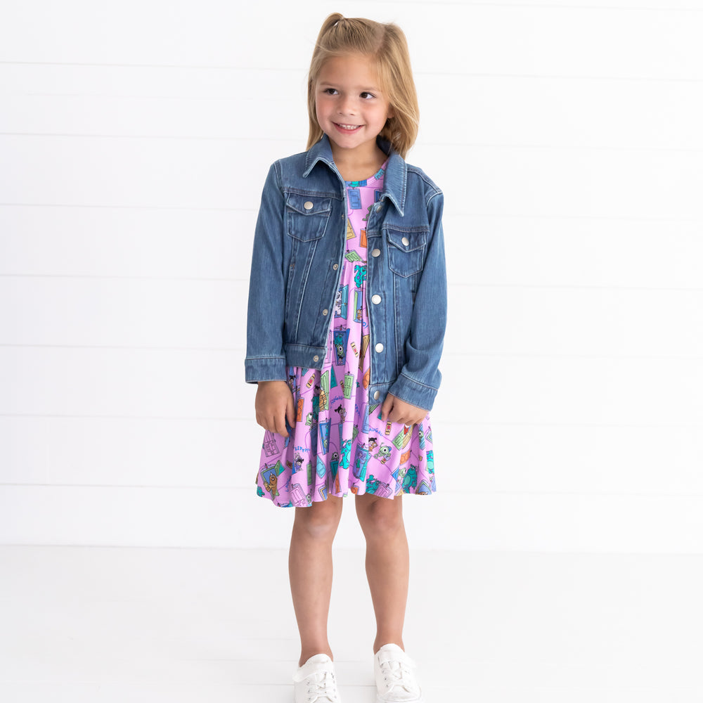 Smiling wearing waring the Disney Monsters, Inc. Scream Team Twirl Dress and Midwash Denim Play Jacket