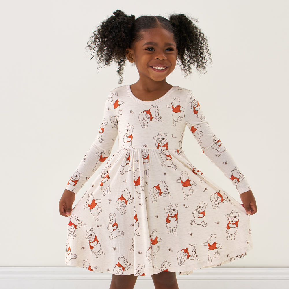 Click to see full screen - Child wearing a Disney Winnie the Pooh twirl dress