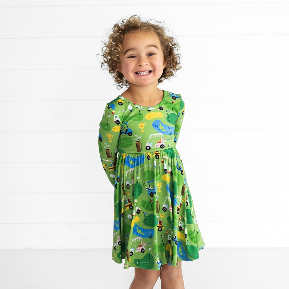 Image of a child wearing a Fairway Fun Twirl Dress