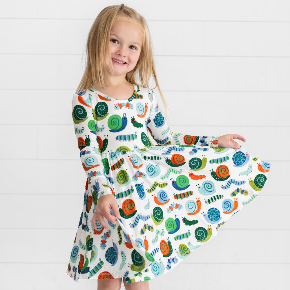 Smiling girl posing while wearing the Inchin' Along Twirl Dress