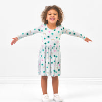 Child posing wearing a Lucky in Love skater dress