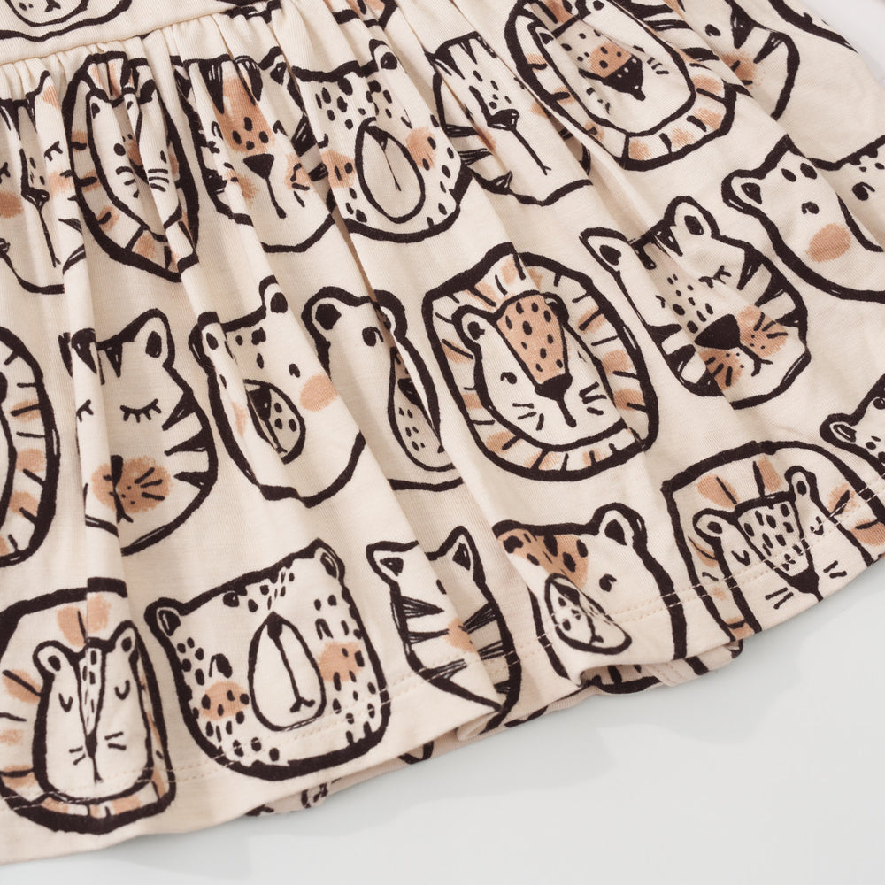 Close-up view of the hem of a Lions, Tigers & Bears long sleeve skater dress with bodysuit