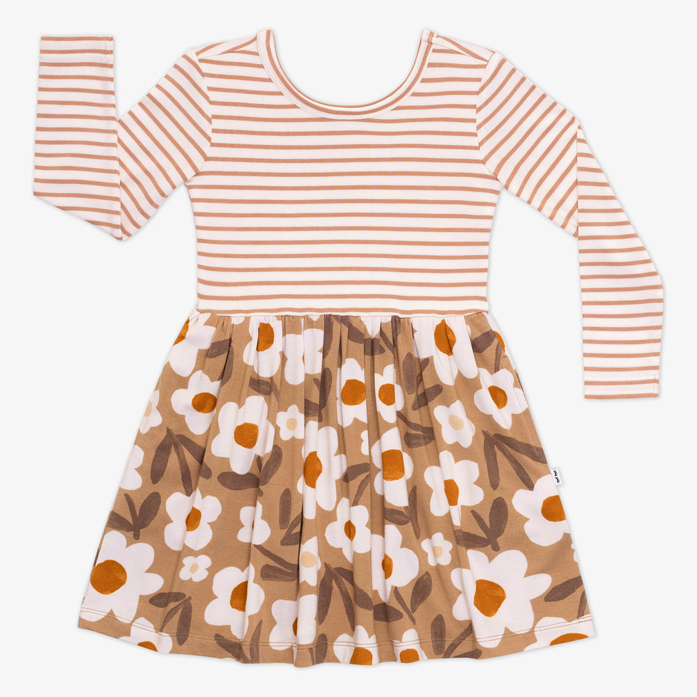 Flat lay of a Daisy Daydream long sleeve twirl dress featuring a tan striped top and tan floral design skirt