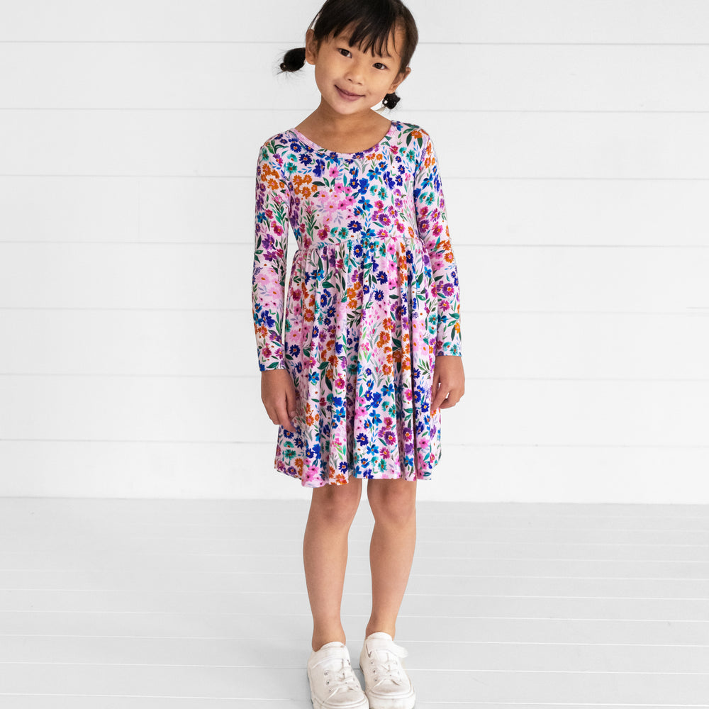 Image of a child wearing a Sweet Pea Floral Twirl Dress