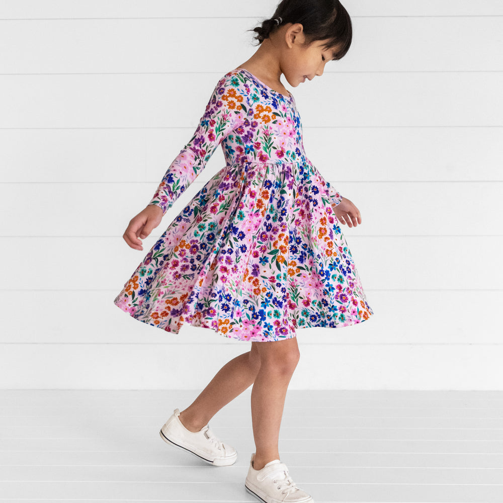 Image of a child spinning around in a Sweet Pea Floral Twirl Dress