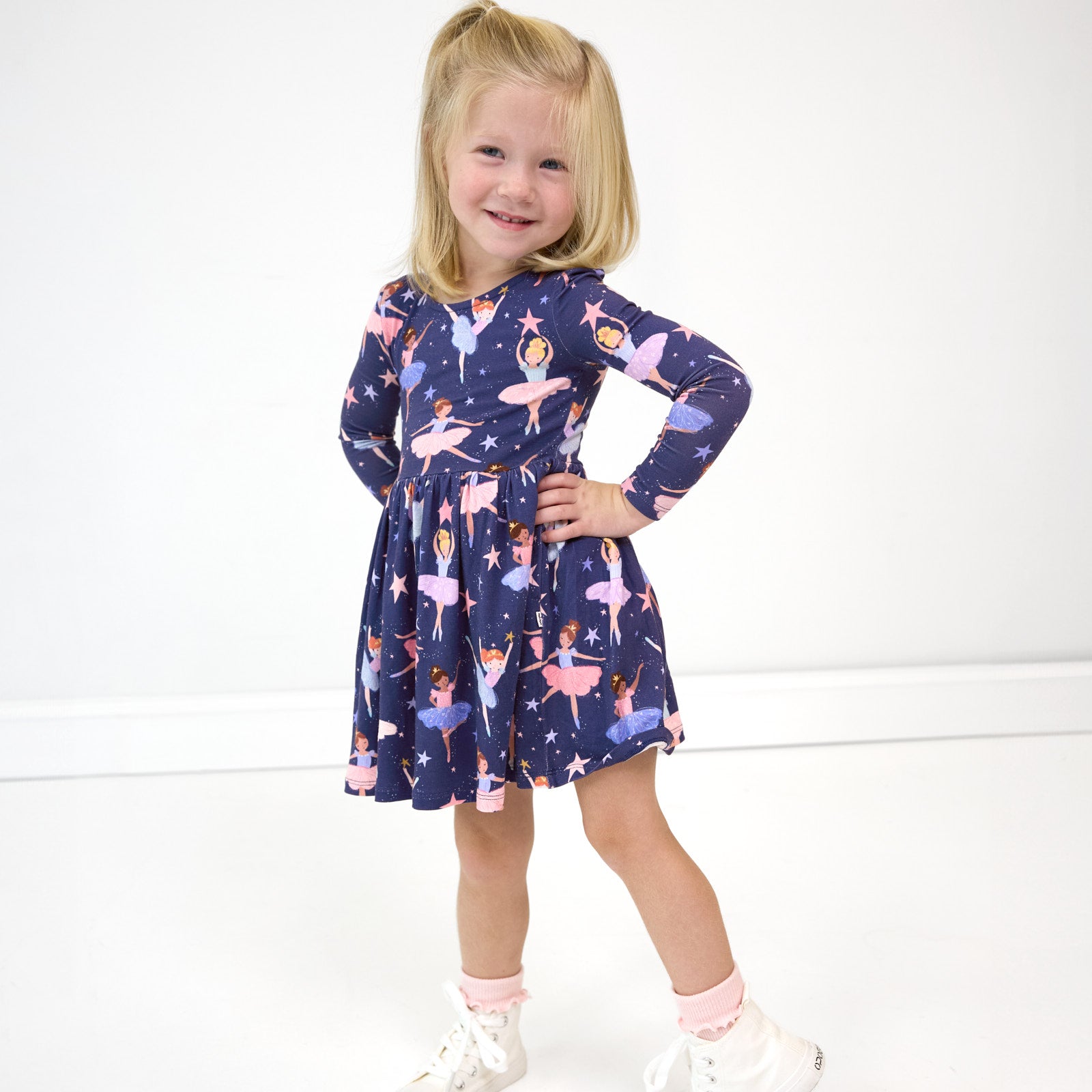 Smiling girl posing while wearing the Twilight Ballet Bow Back Skater Dress with Bodysuit