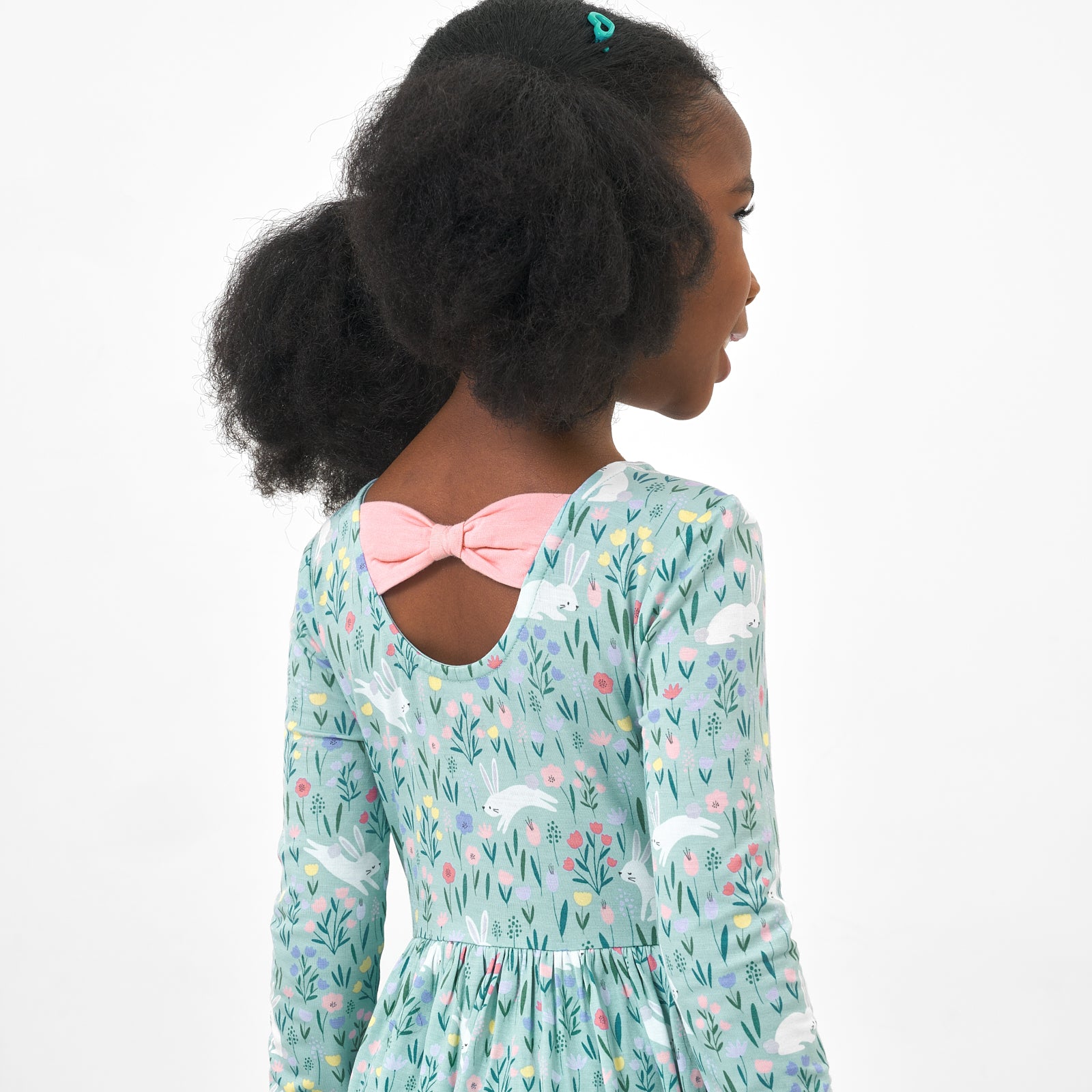 Back view image of a child wearing a Bunny Blossom bow back skater dress