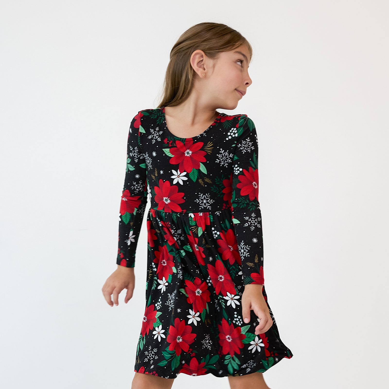 Image of a child wearing a Snowy Blooms Bow Back Skater Dress