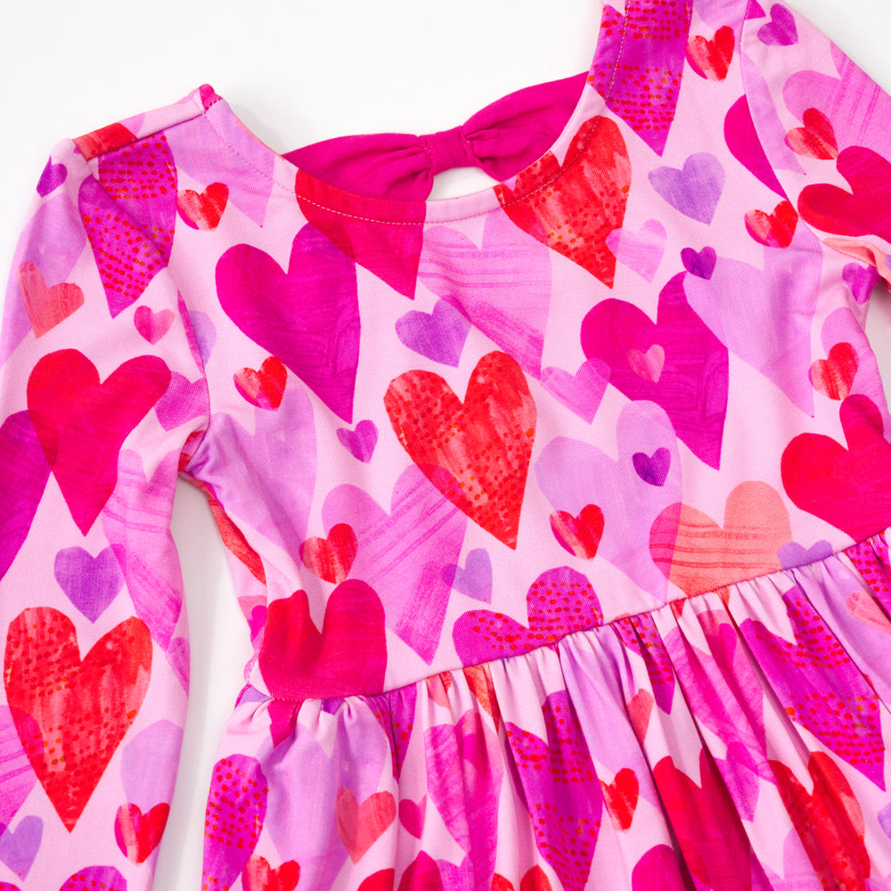 Close up flat lay of a pink hearts & crafts bow back skater dress