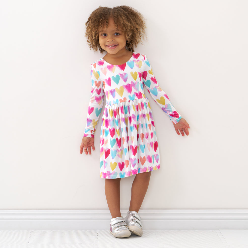 Click to see full screen - Child wearing a Watercolor Love bow back skater dress