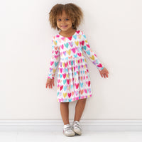 Child wearing a Watercolor Love bow back skater dress