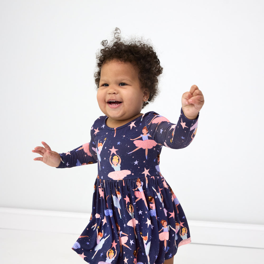 Smiling baby wearing the Twilight Ballet Bow Back Skater Dress with Bodysuit