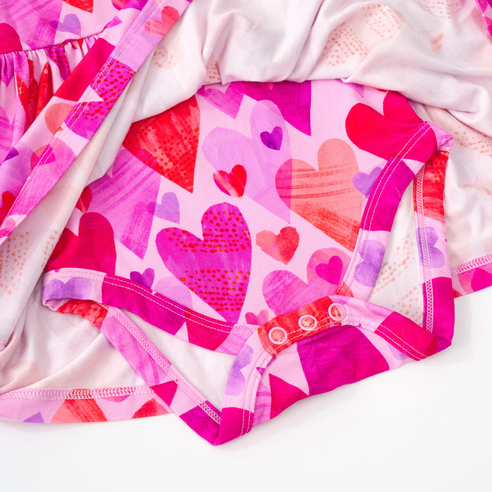 close up view of the hidden bodysuit on a pink hearts & crafts bow back skater dress with bodysuit