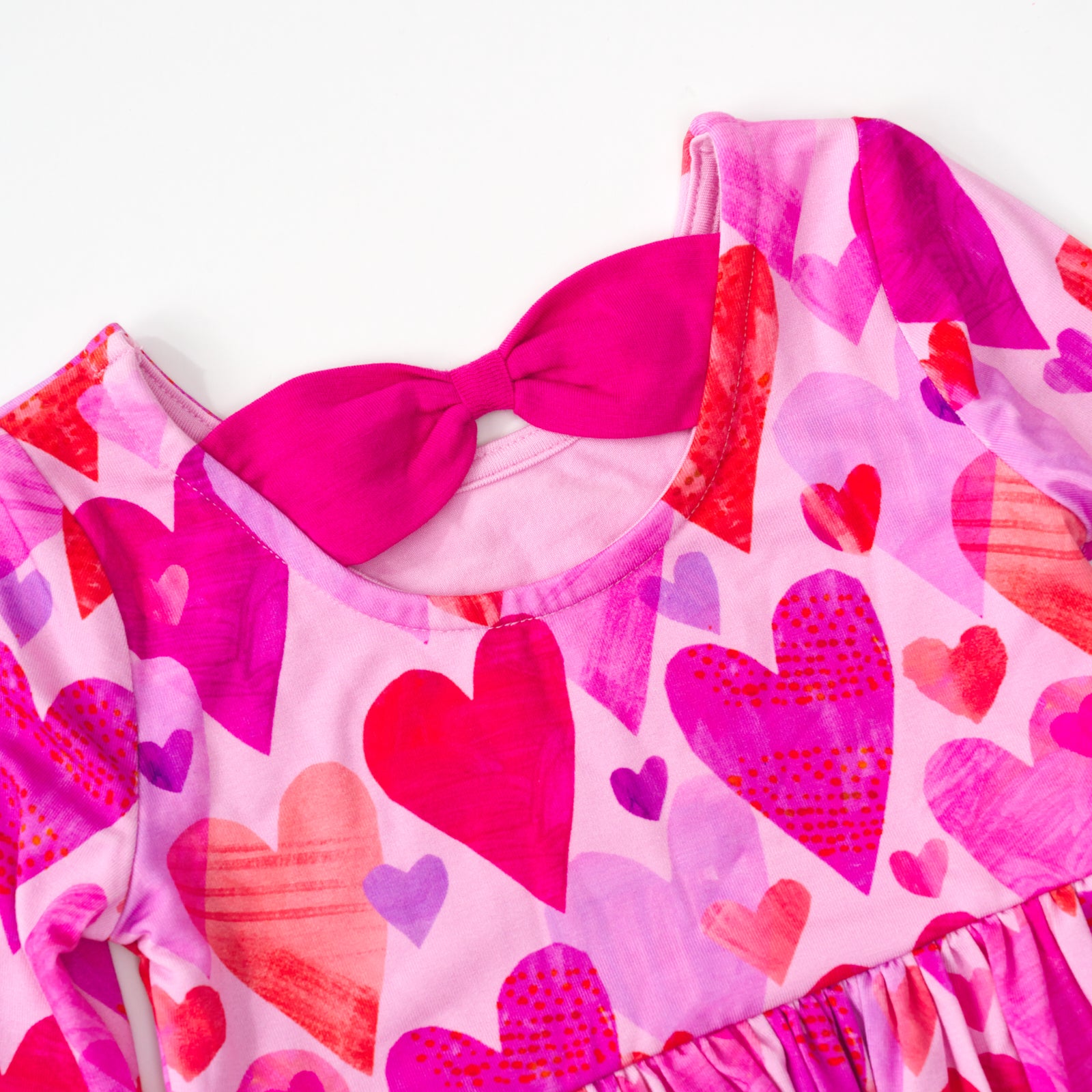 close up view of the bow back on a pink hearts & crafts bow back skater dress with bodysuit