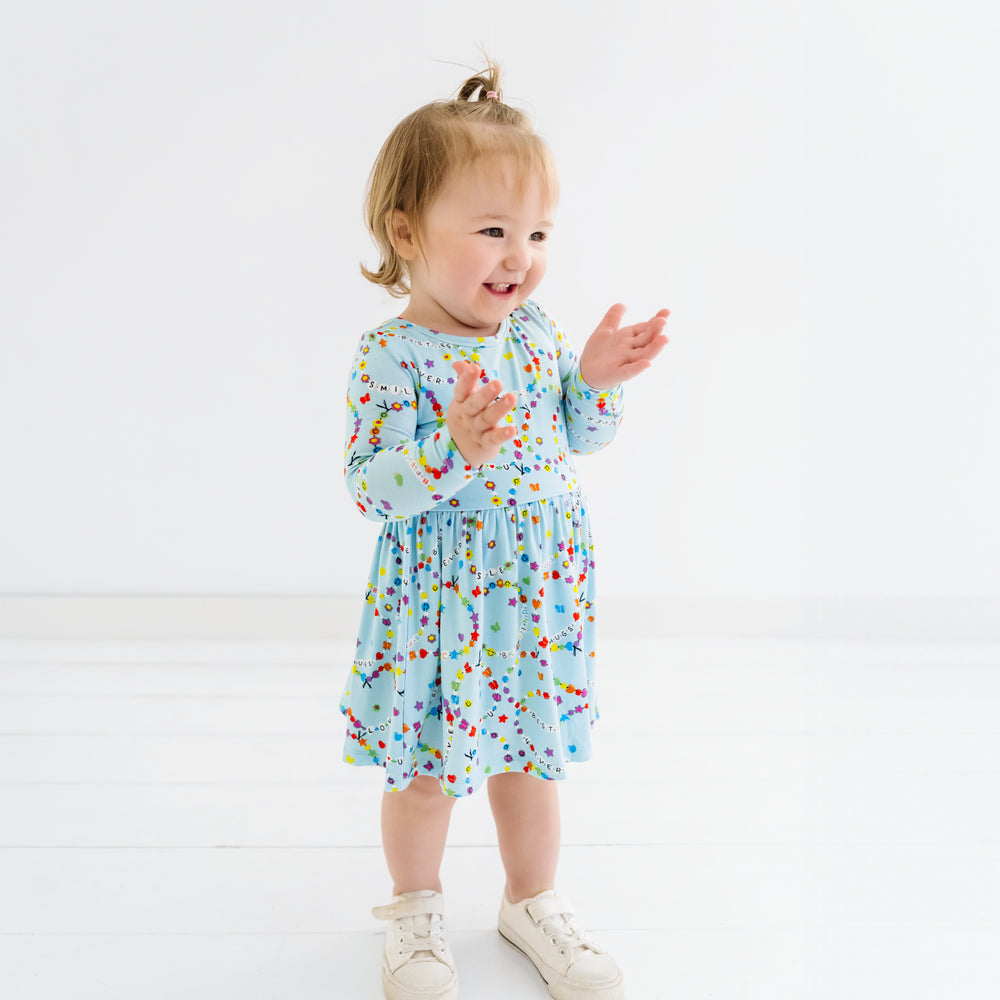 Child clapping wearing a Friends Forever twirl dress with bodysuit