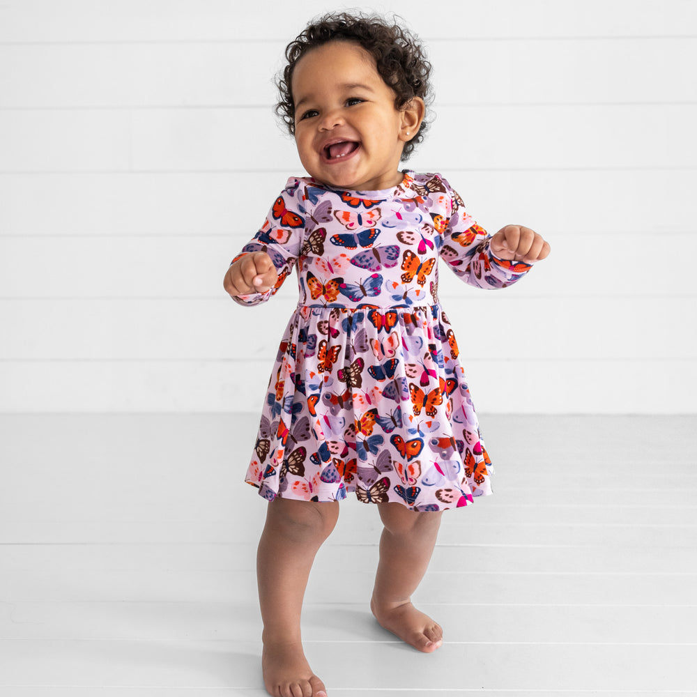 Smiling baby wearing the Butterfly Kisses Twirl Dress with Bodysuit