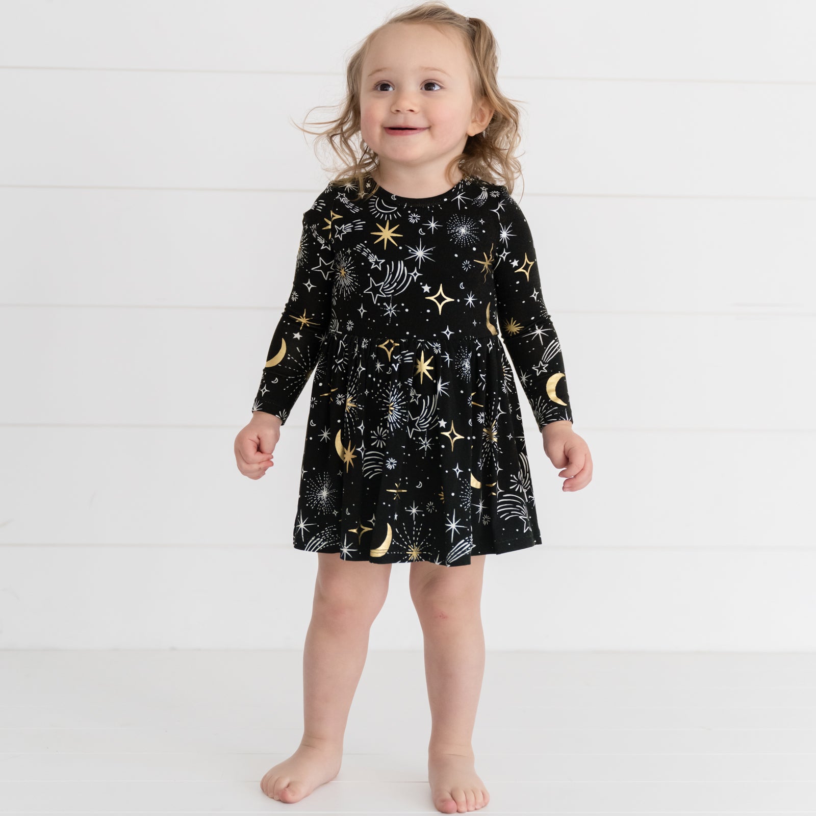 Image of a child wearing a Celebration Stars Twirl Dress with Bodysuit