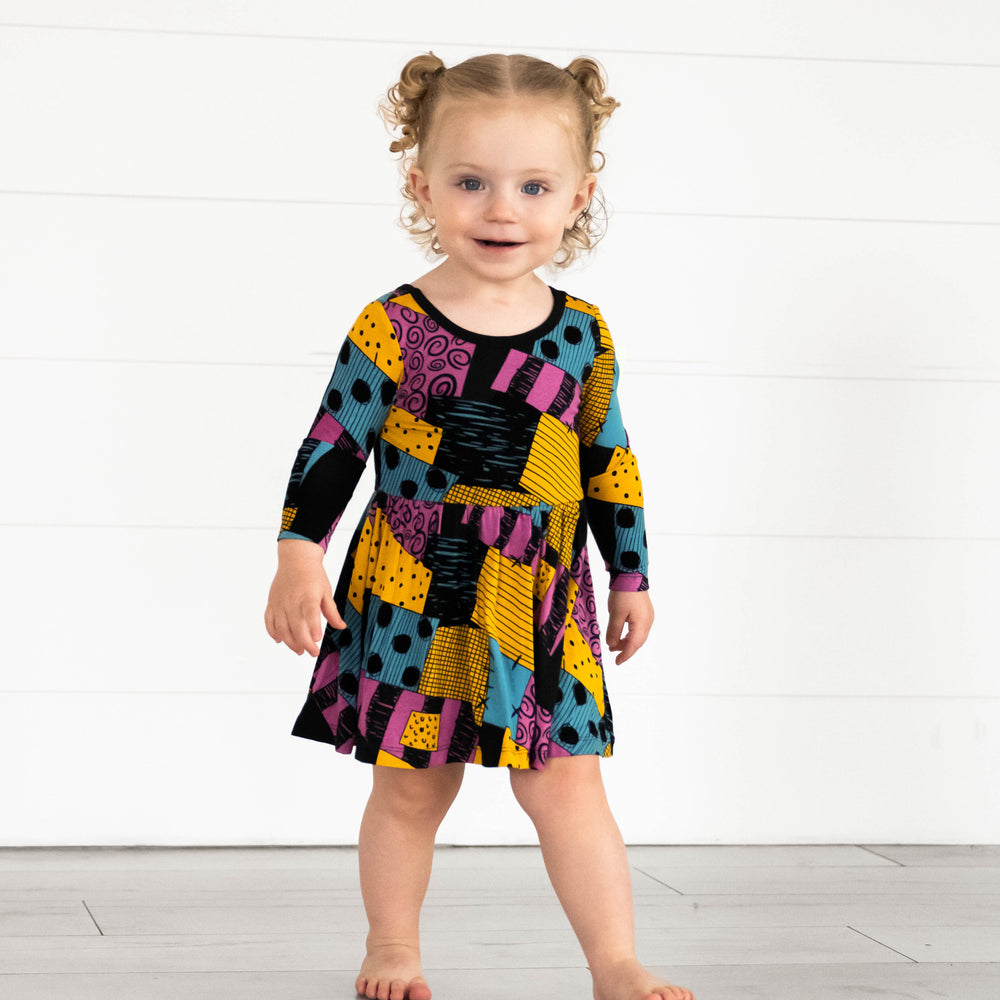 Girl wearing the Disney Sally's Patchwork Twirl Dress with Bodysuit