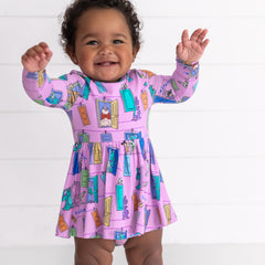 Smiling baby girl wearing the Disney Monsters, Inc. Scream Team Twirl Dress with Bodysuit