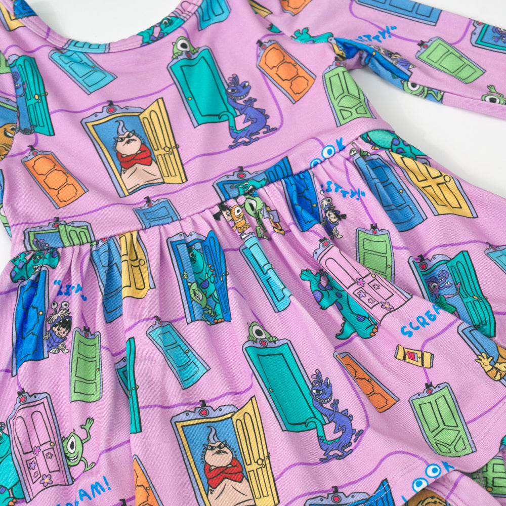 Close up image of the graphic details in the Disney Monsters, Inc. Scream Team Twirl Dress with Bodysuit