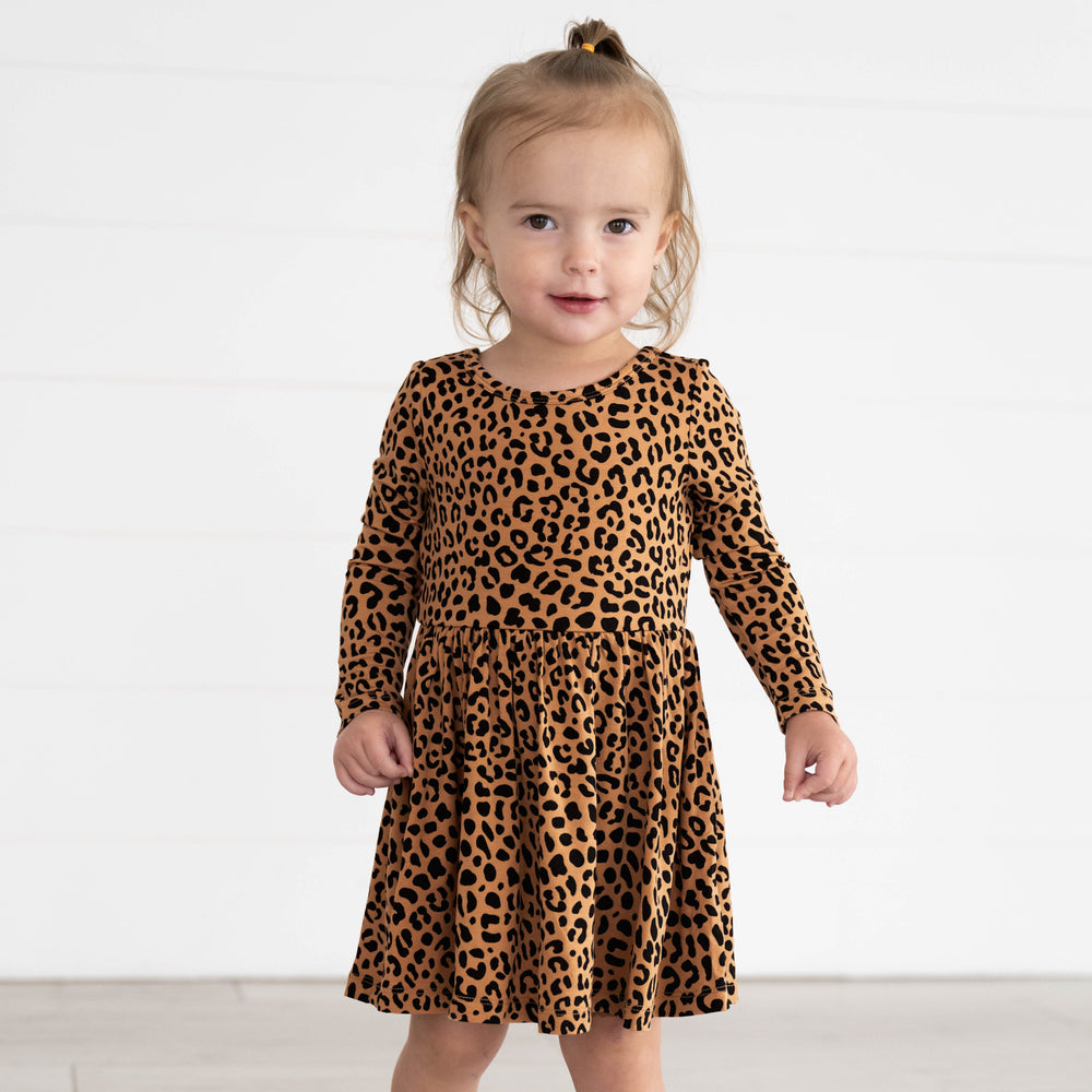 Girl wearing the Classic Leopard Twirl Dress with Bodysuit