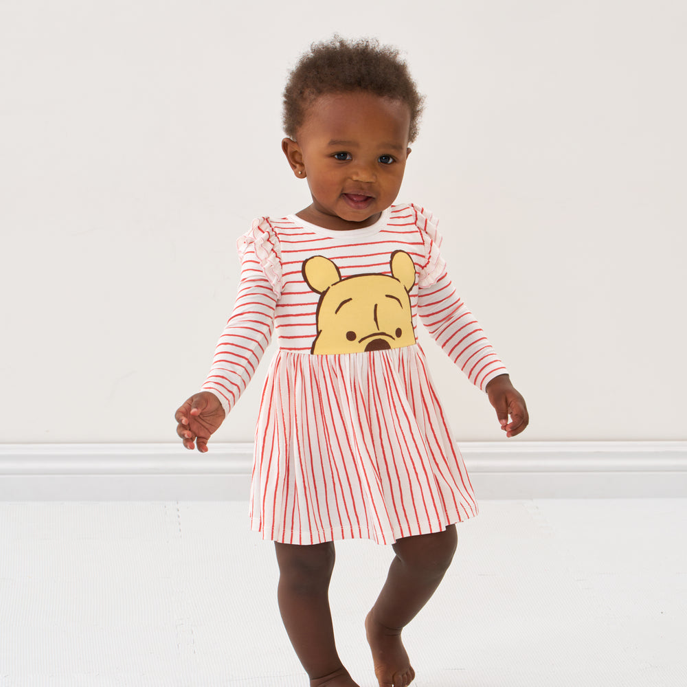 Click to see full screen - Child wearing a Disney Winnie the Pooh flutter skater dress with bodysuit