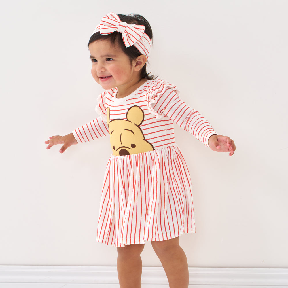 Click to see full screen - Child wearing a Sketchbook Stripes luxe bow headband and matching flutter skater dress