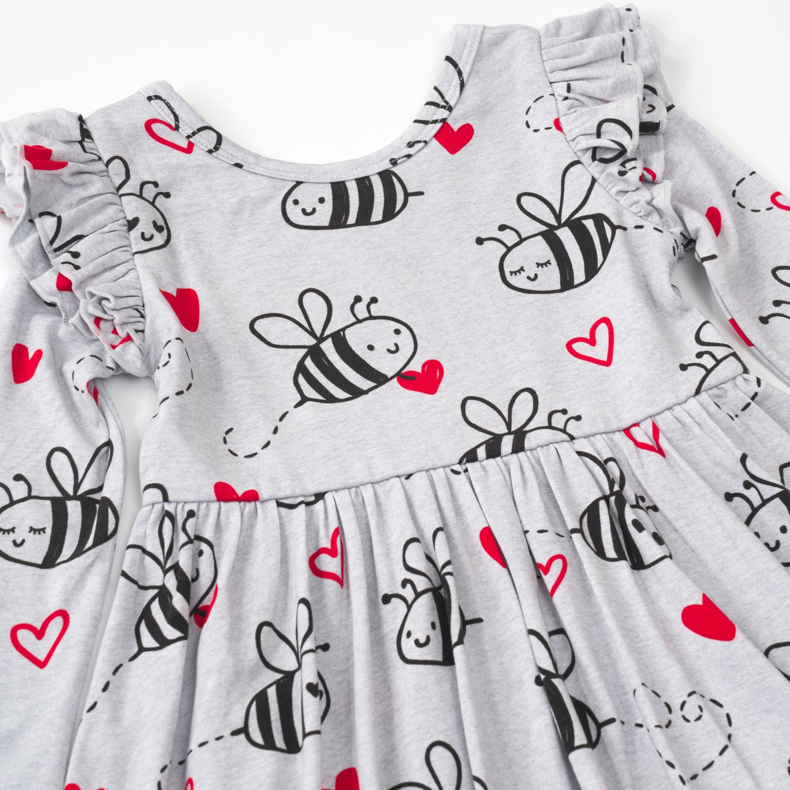 close up flat lay of a bee mine flutter twirl dress with bodysuit