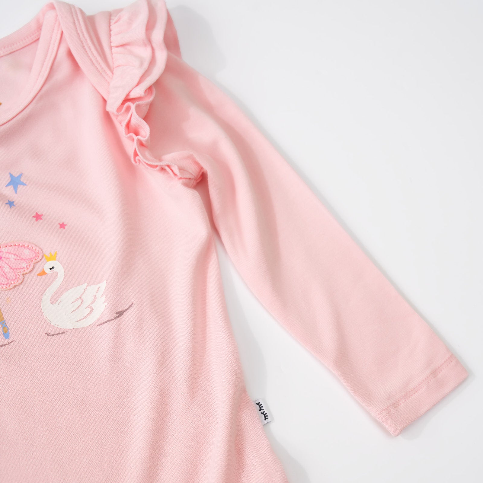 Close up image detailing the flutter sleeve on a Prima Pink Flutter Bodysuit