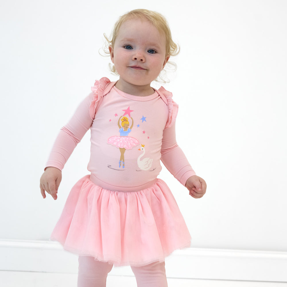 Toddler girl wearing the Prima Pink Flutter Bodysuit and Prima Pink Tutu Legging